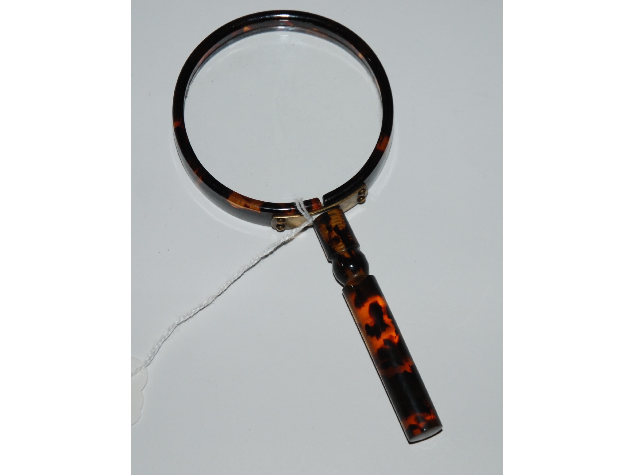 Appraisal: A faux tortoiseshell magnifying glass