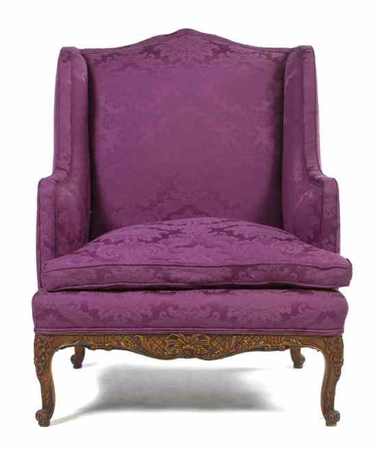 Appraisal: A Louis XV Style Provincial Wingback Armchair having an upholstered