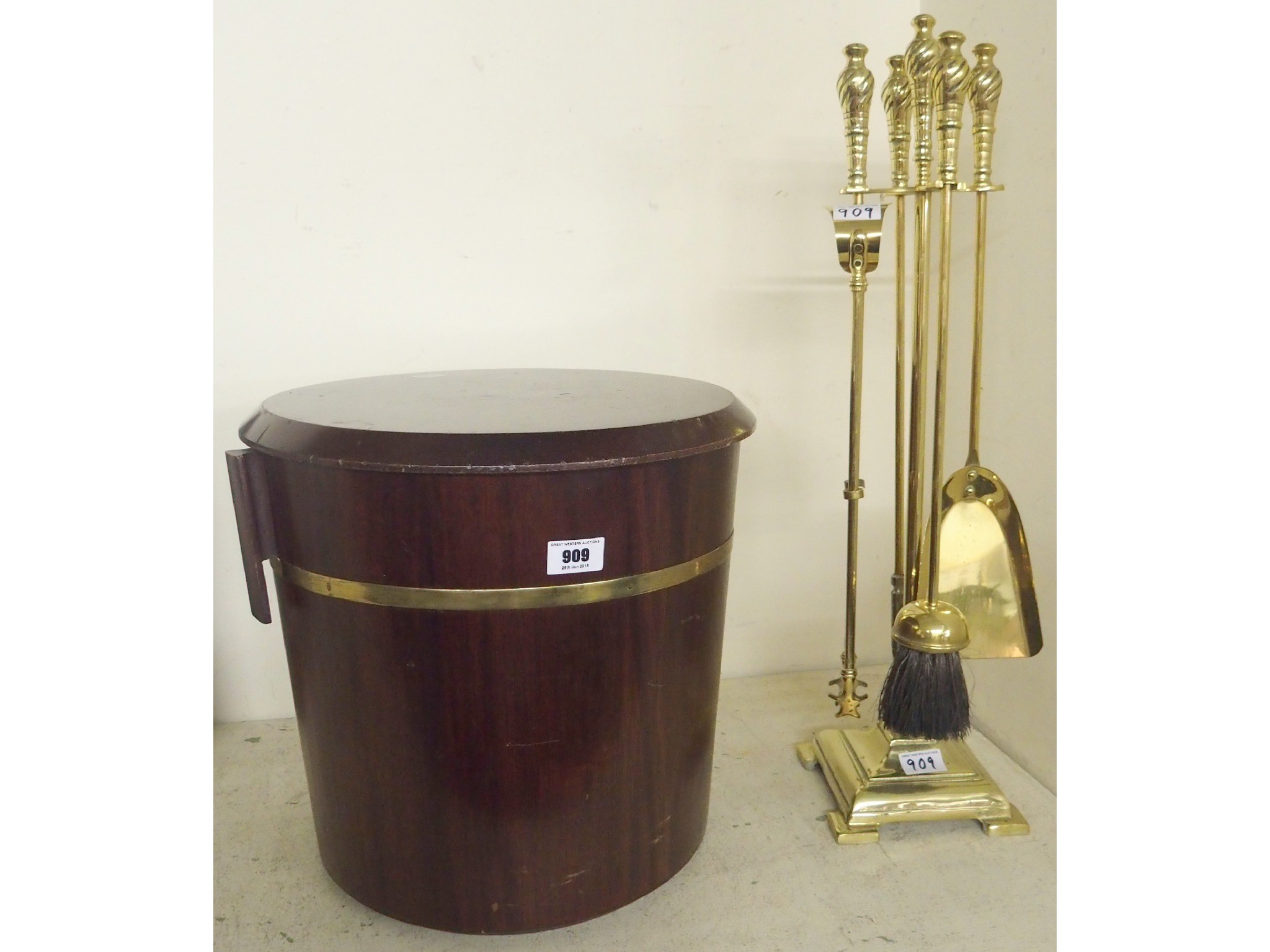 Appraisal: A mahogany brass banded coal bucket and a brass companion