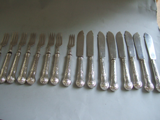 Appraisal: Eight silver bladed fish knives with loaded silver handles and