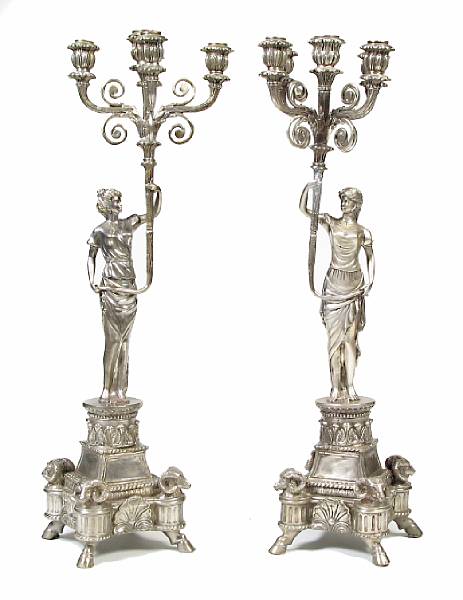 Appraisal: A pair of silvered bronze five light figural candelabra height