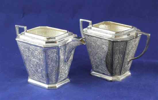 Appraisal: An Indian white metal cream jug and sugar bowl engraved