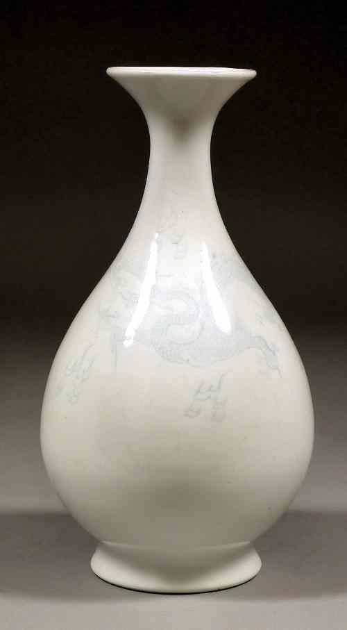 Appraisal: A Chinese white glazed and incised porcelain ''Dragon'' vase the