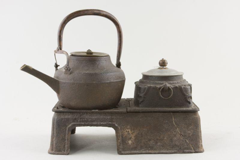 Appraisal: Antique Japanese Hibachi iron construction supports tea pot with brass