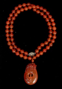 Appraisal: A Carved Agate Bead Necklace and Pendant Carved agate beads