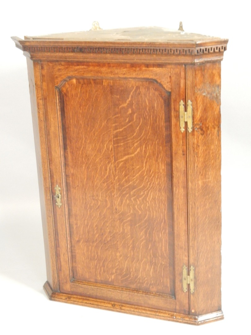 Appraisal: A George III oak corner cabinet the top with a