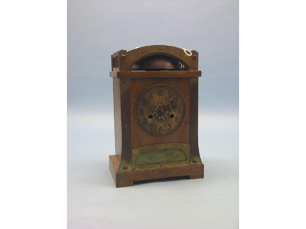 Appraisal: An early th century oak mantel clock featuring embossed brass