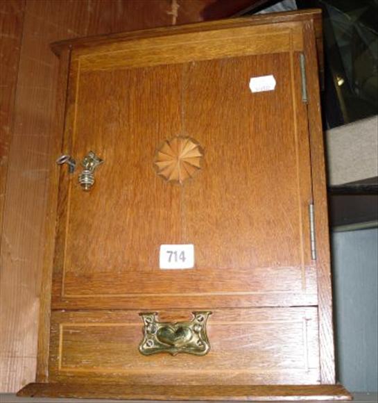 Appraisal: An Edwardian oak and satinwood inlaid smoker's cabinet