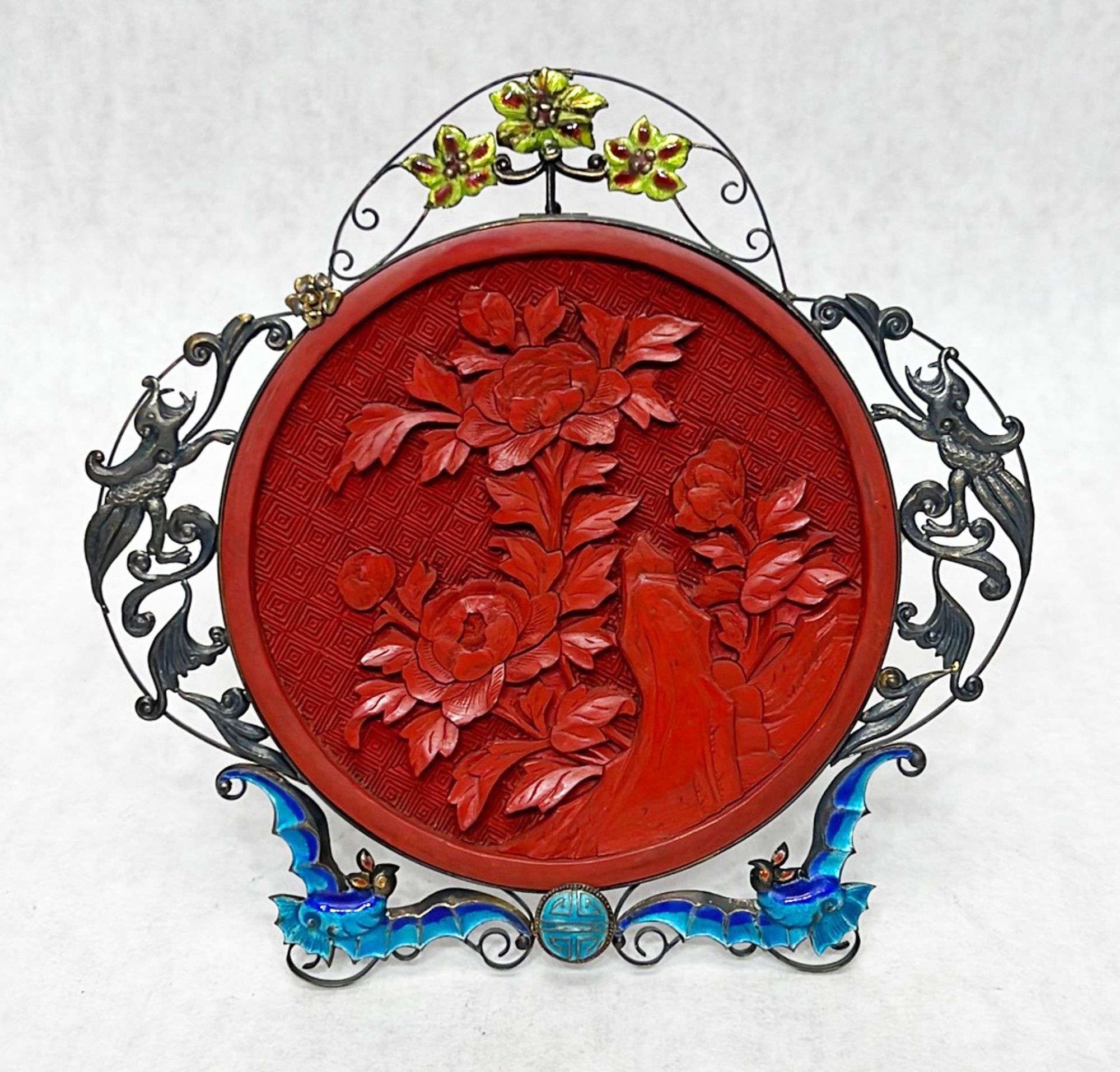 Appraisal: Chinese carved cinnabar plaque in enamel silver frameEarly to mid