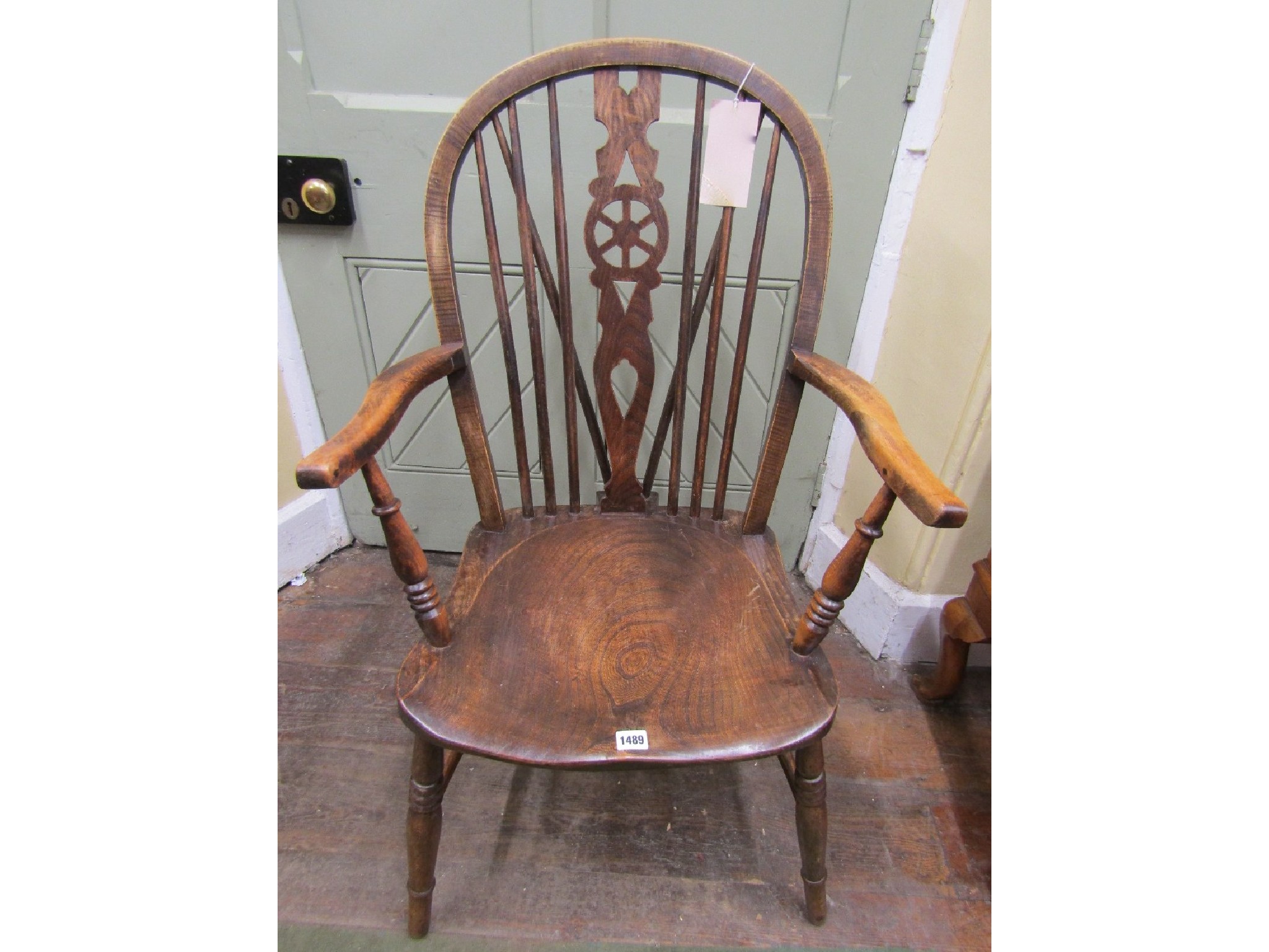 Appraisal: A Windsor wheelback elbow chair in mixed woods with elm