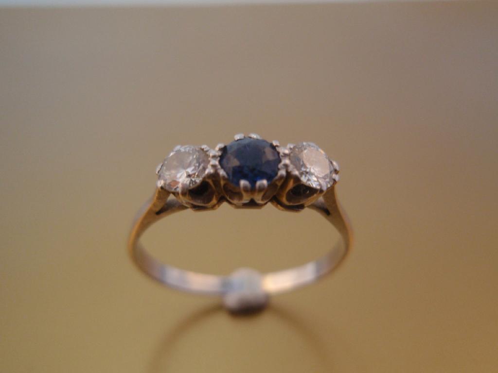 Appraisal: A three stone ring of two diamonds round brilliant cut