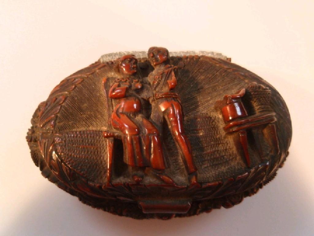 Appraisal: A Georgian carved nut snuff box with figures in relief