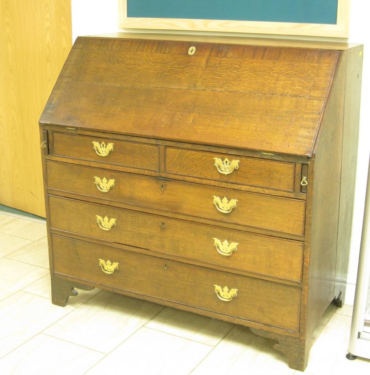 Appraisal: An antique oak Bureau cross-banded with mahogany fitted interior above