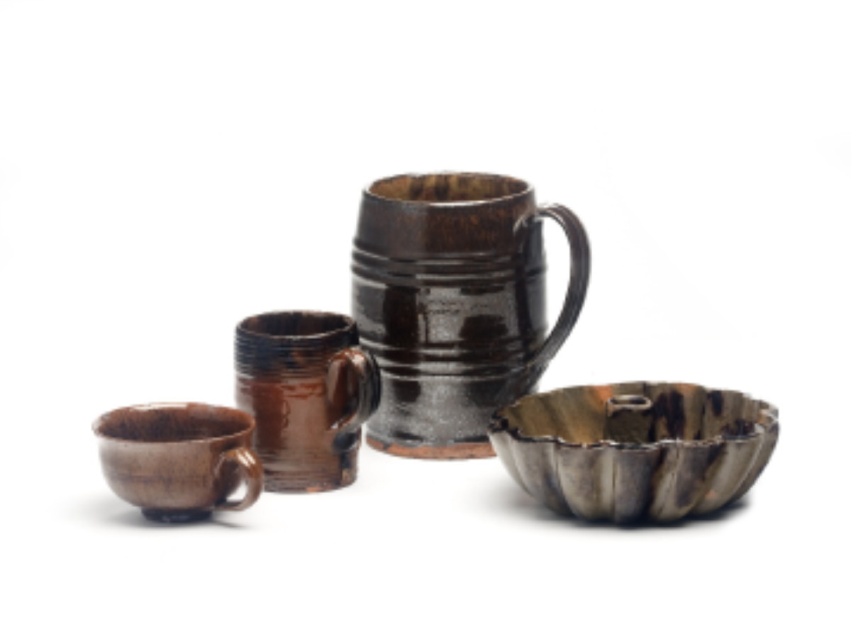 Appraisal: TWO NEW ENGLAND GLAZED REDWARE MUGS AND A TEACUP NINETEENTH