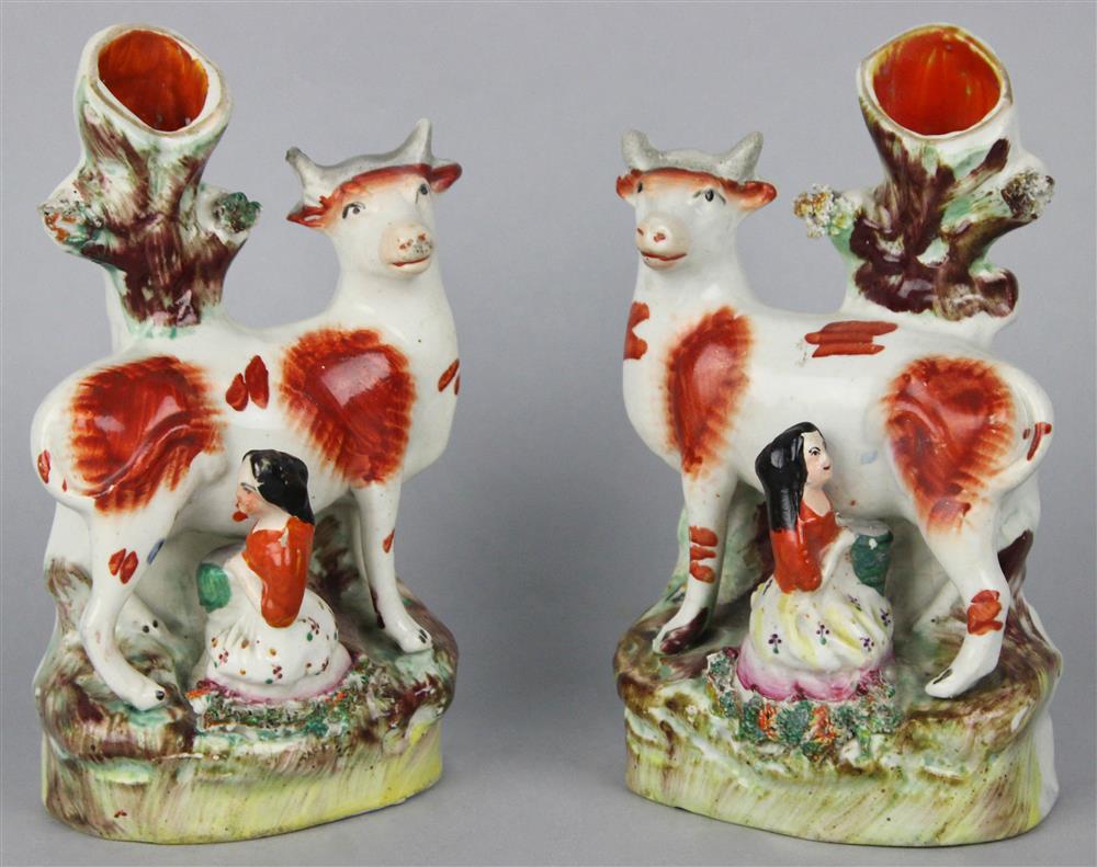 Appraisal: PAIR OF STAFFORDSHIRE MILKING GROUP SPILL VASES each modeled as