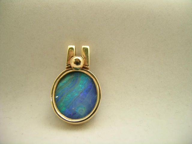 Appraisal: Oval tinted opal in K gold pendant with gold-filled Monet