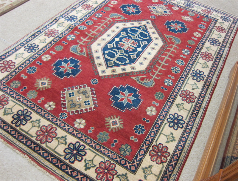 Appraisal: HAND KNOTTED ORIENTAL AREA RUG Pakistani-Caucasian geometric and stylized flower