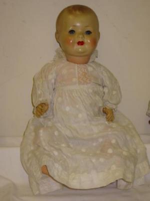 Appraisal: A composition baby doll with blue glass sleeping eyes closed