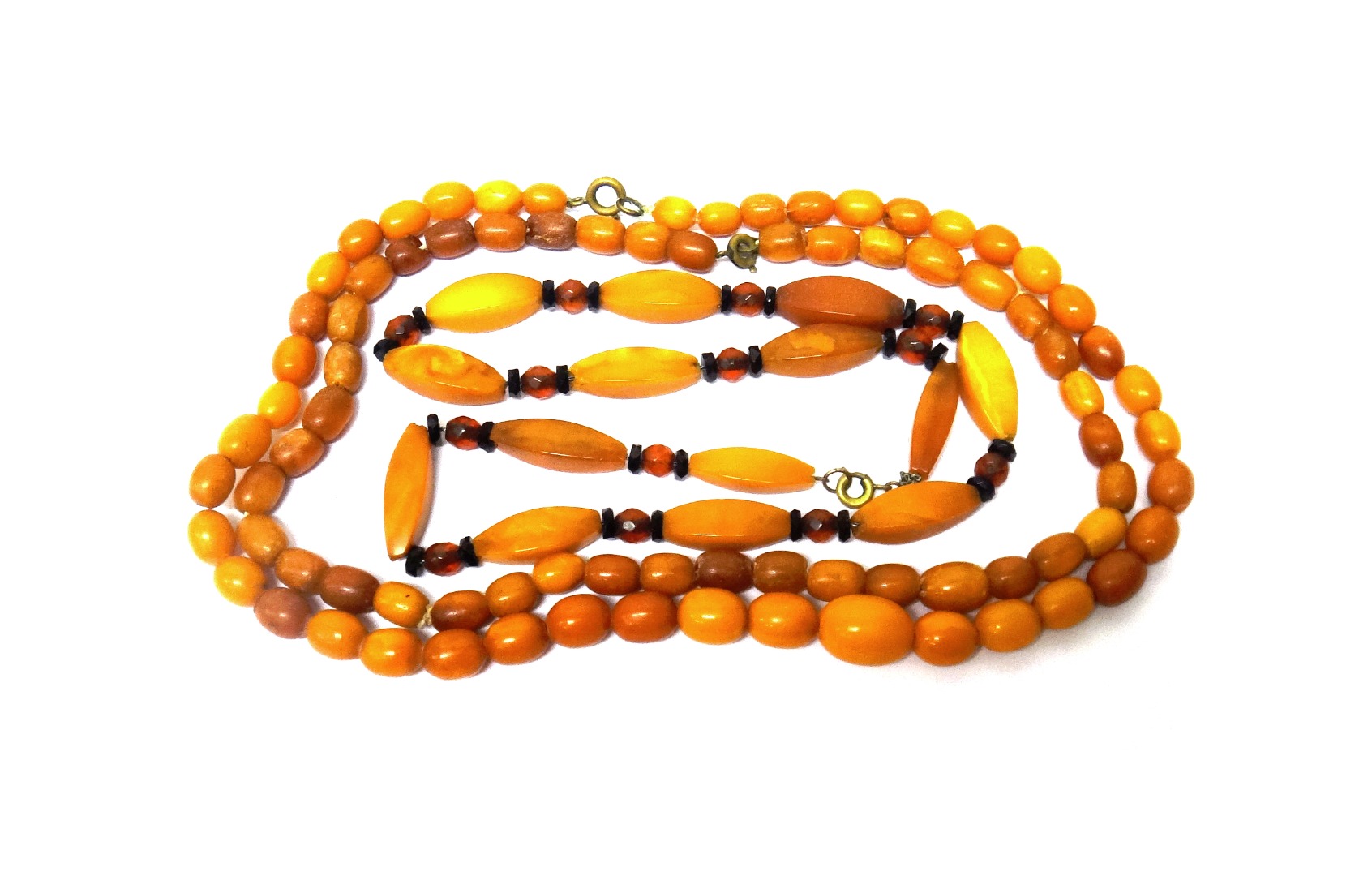 Appraisal: Two single row necklaces of oval vary coloured butterscotch coloured