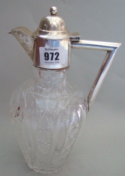 Appraisal: A silver mounted faceted glass claret jug with an angular