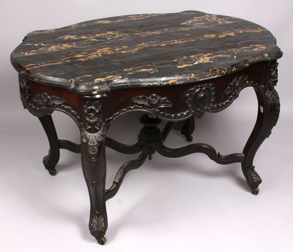 Appraisal: th Century Victorian heavily carved table with black and brown