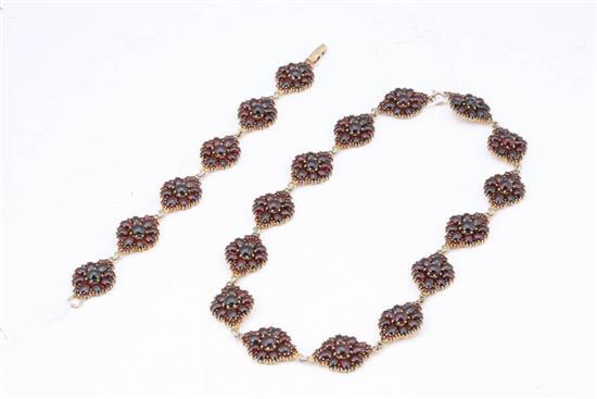 Appraisal: GARNET BRACELET AND NECKLACE Composed of elliptical links of cabachon