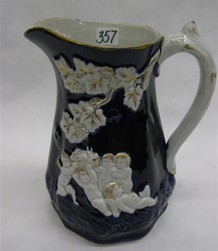 Appraisal: ENGLISH GLAZED POTTERY PITCHER c having raised cherubs and leaves