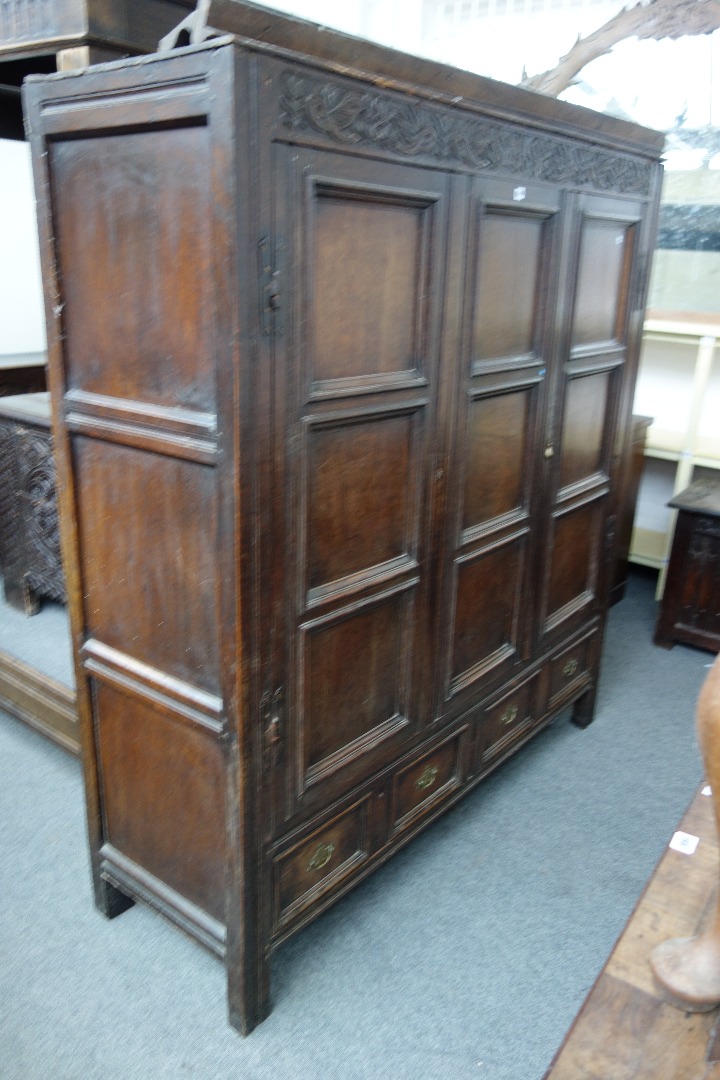 Appraisal: An th century oak nine panel hall cupboard with two