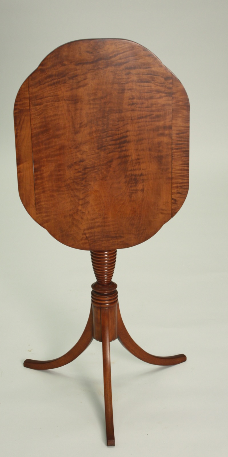 Appraisal: ANTIQUE AMERICAN TILT-TOP SPIDER-LEG CANDLESTAND Circa In strong tiger maple