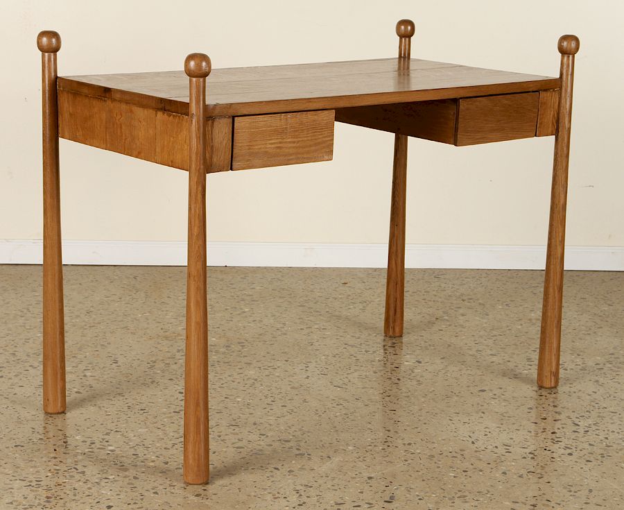 Appraisal: AN OAK WRITING DESK IN THE MANNER OF JEAN ROYER