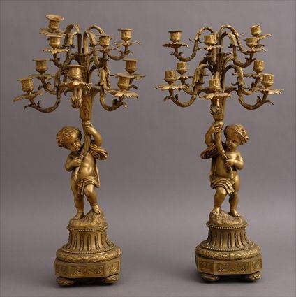 Appraisal: PAIR OF LOUIS XVI-STYLE GILT-BRONZE NINE-LIGHT CANDELABRA Each modeled as