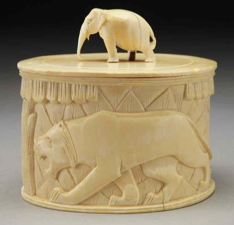 Appraisal: African carved ivory lidded box depicting animals International buyers should