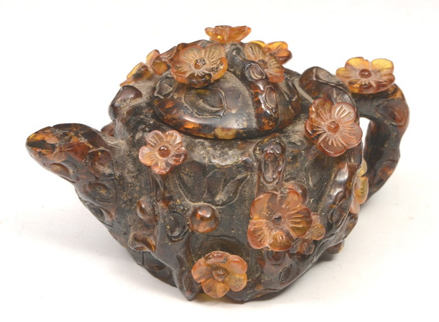 Appraisal: AN ANTIQUE CHINESE CARVED AMBER MINIATURE TEAPOT AND COVER with