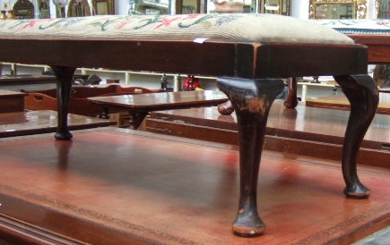 Appraisal: A th century mahogany framed long low foot stool raised