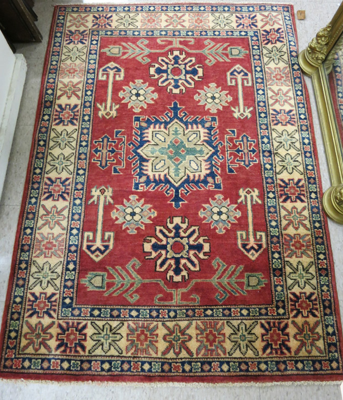 Appraisal: HAND KNOTTED ORIENTAL AREA RUG Pakistani-Caucasian featuring colorful geometric and