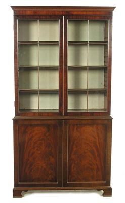 Appraisal: A mahogany bookcase cabinet the cavetto moulded cornice above a