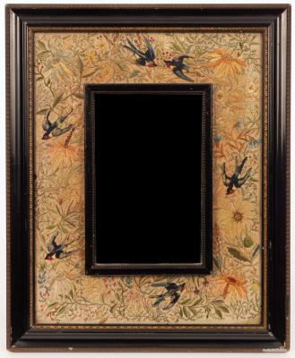 Appraisal: A needlework framed wall mirror swallows amidst foliage the mirror