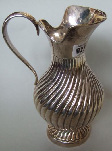 Appraisal: A Turkish jug of baluster form with spiral fluted decoration