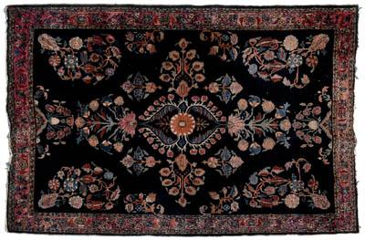 Appraisal: Sarouk rug floral designs on rich blue black field s