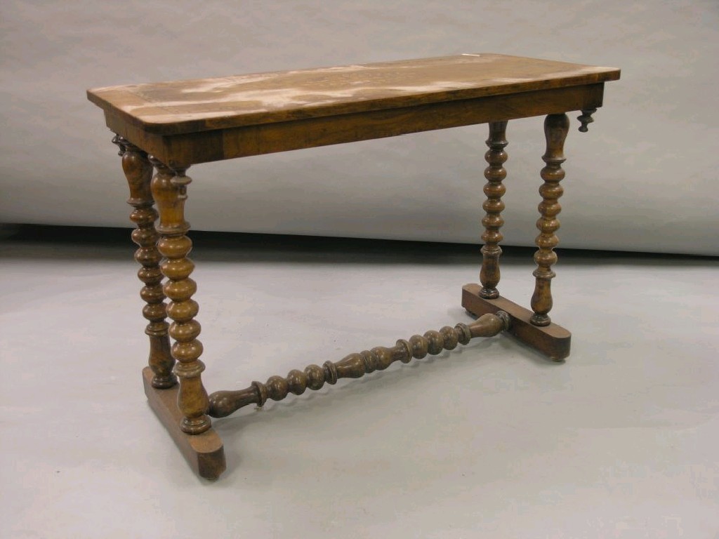 Appraisal: A Victorian inlaid walnut stretcher table the burr-veneered top inlaid