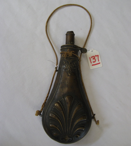 Appraisal: NINETEENTH CENTURY SHOTGUN POWDER FLASK brass body embossed clamshell pattern