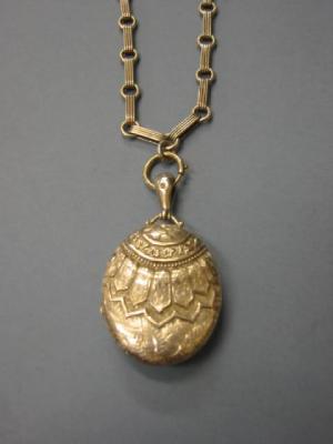 Appraisal: A VICTORIAN SILVER LOCKET ON CHAIN the oval hinged locket