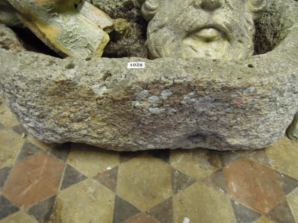 Appraisal: A weathered rough hewn D shaped granite stone trough