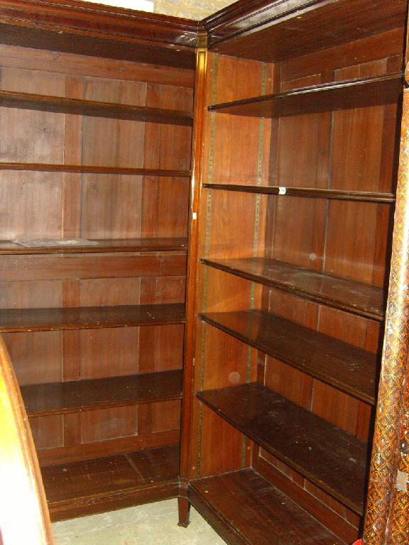 Appraisal: A substantial mahogany corner bookcase of full height with adjustable