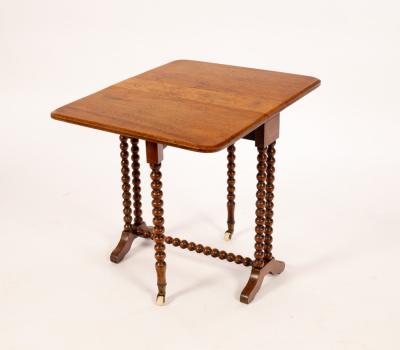 Appraisal: A walnut oval two-flap table on bobbin turned legs cm