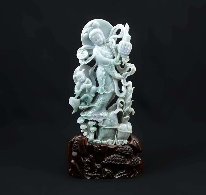 Appraisal: CHINESE CARVED JADEITE GUAN YIN AND ATTENDANT Apple green and