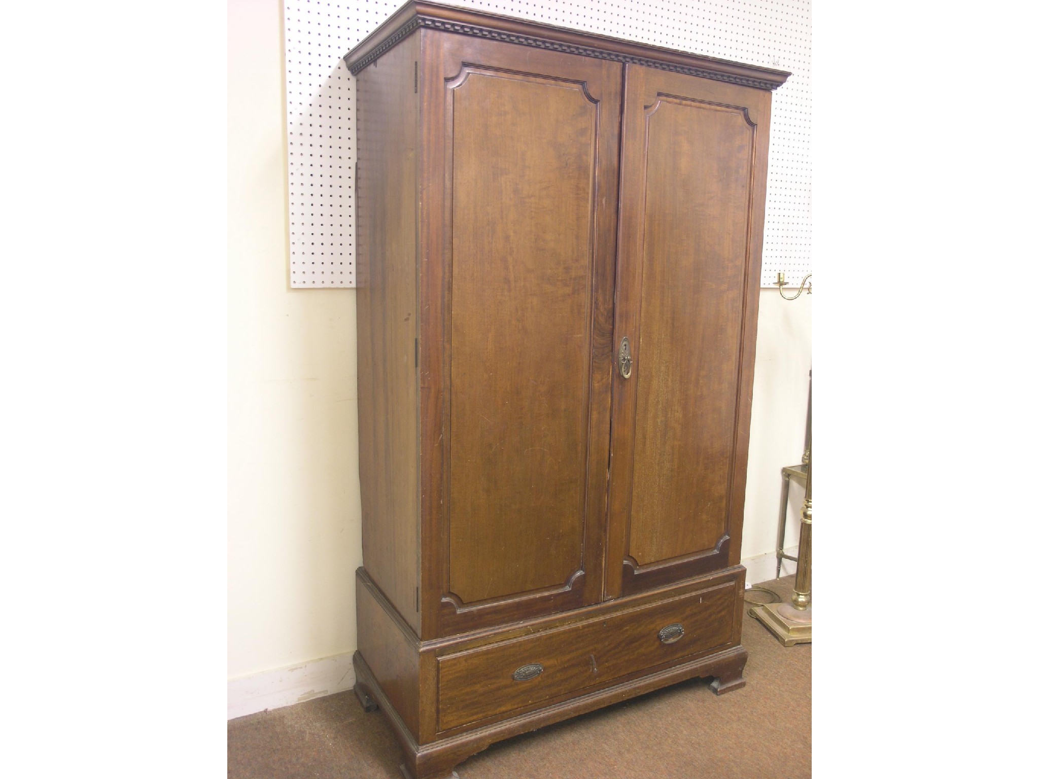 Appraisal: A mahogany wardrobe pair of three-quarter length panelled doors enclosing