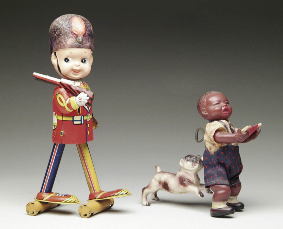 Appraisal: TWO JAPANESE CELLULOID TOYS Consisting of a black boy eating