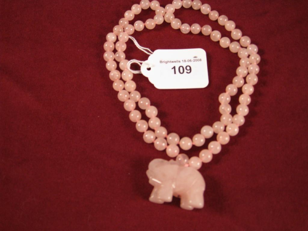 Appraisal: A rose quartz bead Necklace with elephant pendant an agate