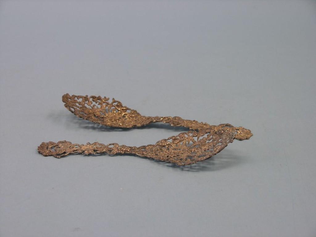 Appraisal: Two matching ornamental silver server spoons elaborately cast with amorini